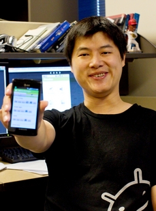 Computer science doctoral student Yunsong Meng displays a smartphone image of a social media app he helped create. The Eventor app is designed to help people organize events based on their shared interests. 