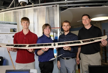 ASU students (from left) Cory Peterson, Michael Yach, Mark Garrison and Cameron Simoes display the solar-airplane model that won them the top electrical engineering senior-year design project award for the 2010-2011 school year.