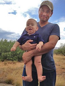 Andres Neal, holding his son, John. 