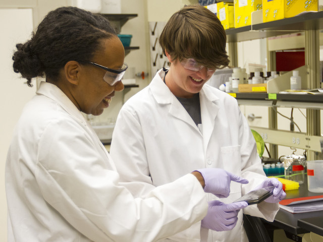 Karmella Haynes (left) is leading research to explore the capability of genetically engineered proteins to reactivate tumor suppressors inside body cells to prevent the onset of cancer, or arrest its development. Photo by Jessica Hochreiter/ASU.