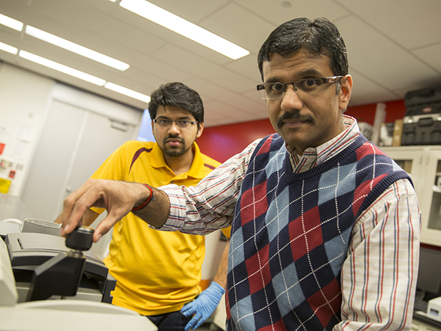 Arizona State University engineer Narayanan Neithelath (at right) will lead an international project to develop ways of making concrete pavements more durable. The work will give several ASU graduate students opportunities to gain research experience. Civil engineering doctoral student Akash Dakhane (at left) will assist Neithalath with tasks such as using infrared spectroscopy to identify the composition of phase-change materials that will be used to development new kinds of pavement. Photography: Nora Skrodenis/ASU