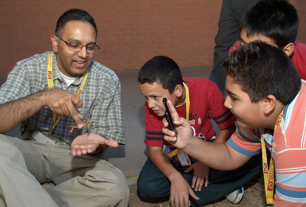 ASU Associate Professor and Assistant Dean of Engineering Education Tirupalavanam Ganesh uses a small tortoise to explain to young students how the animal's natural behaviors can provide answers to ways to design technologies that solve human problems. 